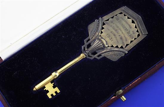 A George V Art Deco silver gilt key presented on the opening of the Avon Rubber Company offices,